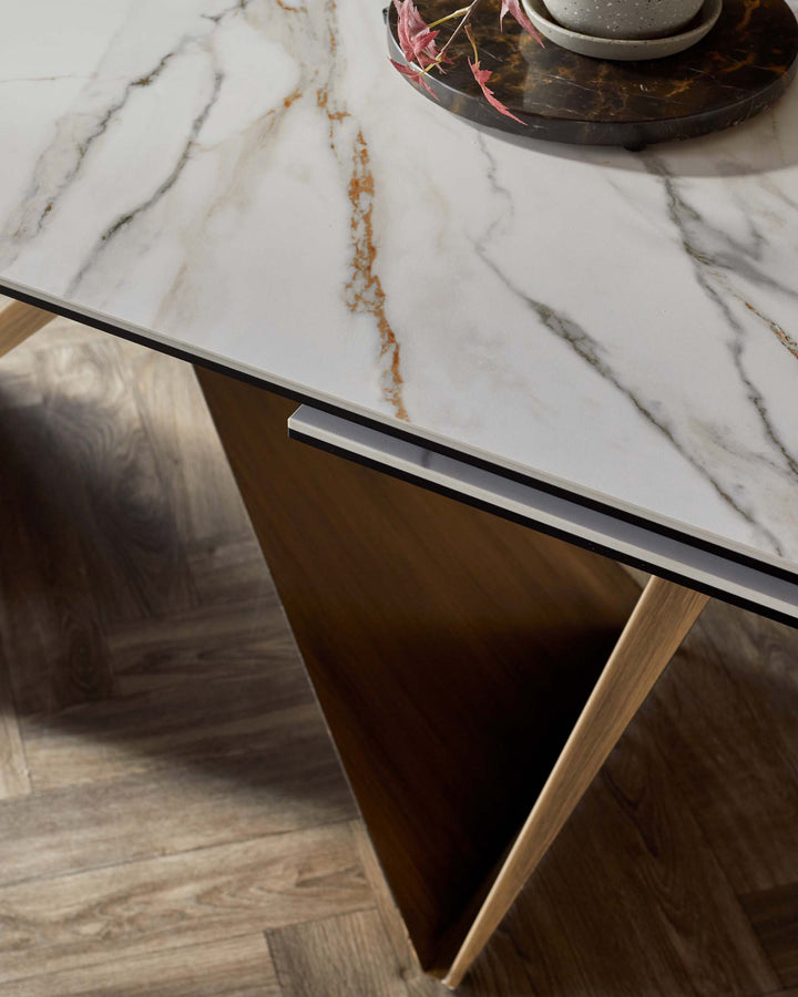 Stylish dining table featuring a marble top with elegant veining and sleek wooden legs for a modern look.