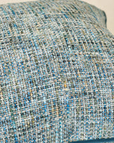 Close-up of Callie large cushion in blue, showing textured woven fabric with white, blue, and green speckled pattern.