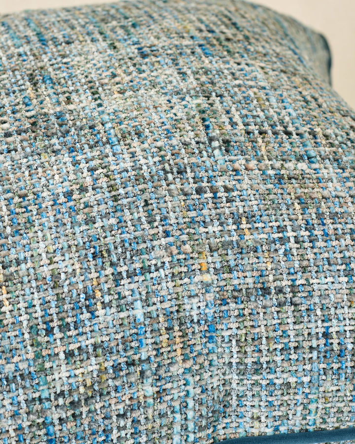 Close-up of Callie large cushion in blue, showing textured woven fabric with white, blue, and green speckled pattern.