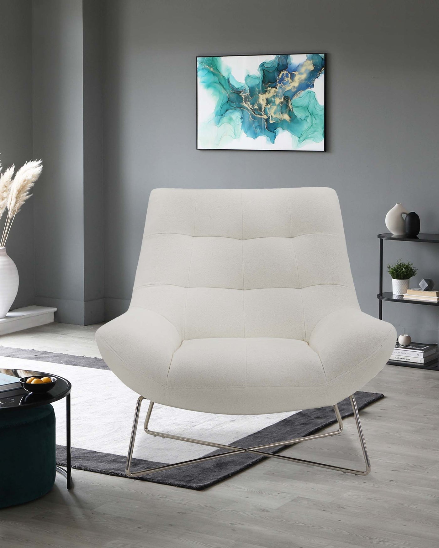 Modern cream-colored upholstered armchair with a tufted backrest and a unique metal base in a sleek, contemporary living room setting.