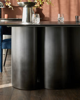 Carlo 8-seater dining table with dark grey ceramic top and brushed stainless steel cylindrical base.