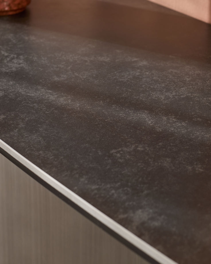 Carlo console table in dark grey ceramic with white trim detail, angled close-up view.