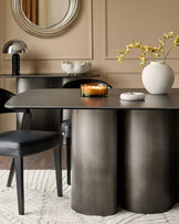 Carlo 8-seater dining table in dark grey ceramic with cylindrical base, styled in modern dining room setting.