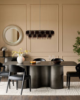 Carlo 8-seater dining table in dark grey ceramic with curved cylindrical base, styled with black chairs and pendant lighting.