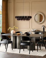 Carlo 8-seater dining table in dark grey ceramic with curved pedestal base, styled in modern dining room setting.