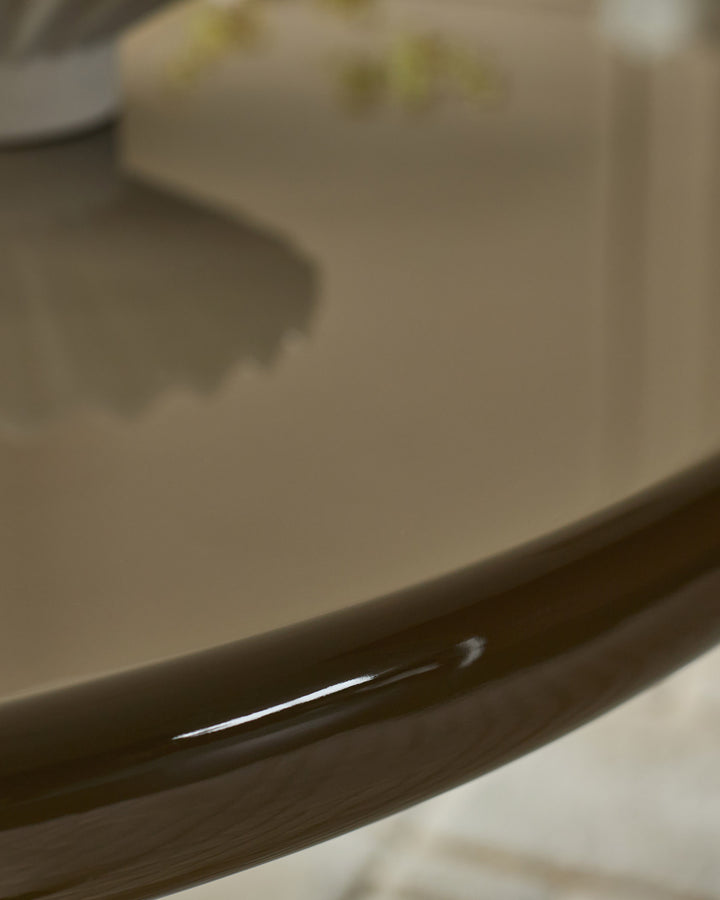 Gloss olive-green coffee table edge detail showing smooth, reflective finish and curved corner design.