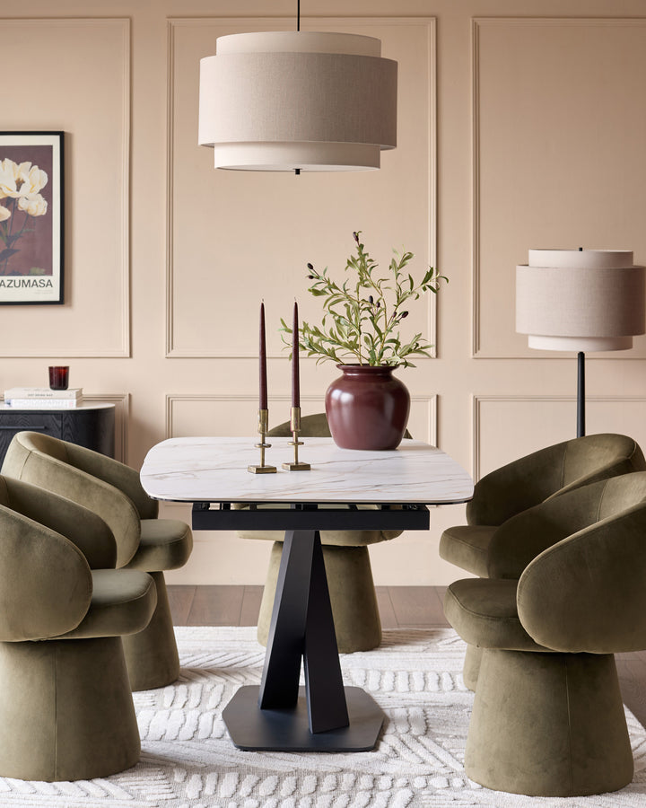 Carter extending dining table in natural ceramic with black pedestal base, shown in modern dining room setting.