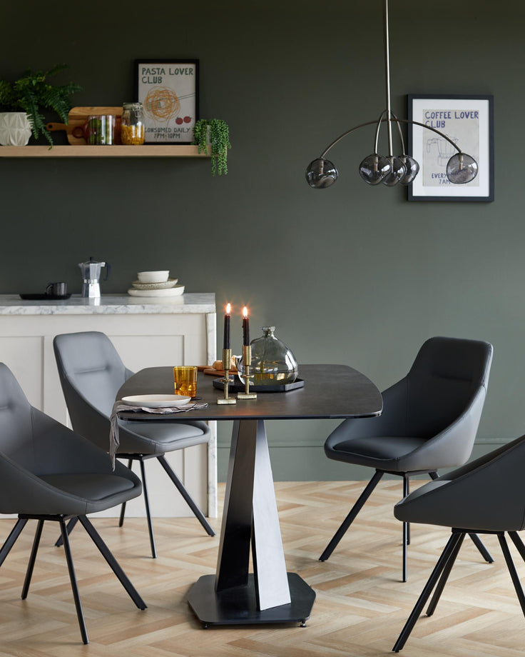 A modern dining set with grey chairs, dark table, and stylish lighting, perfect for contemporary dining spaces.