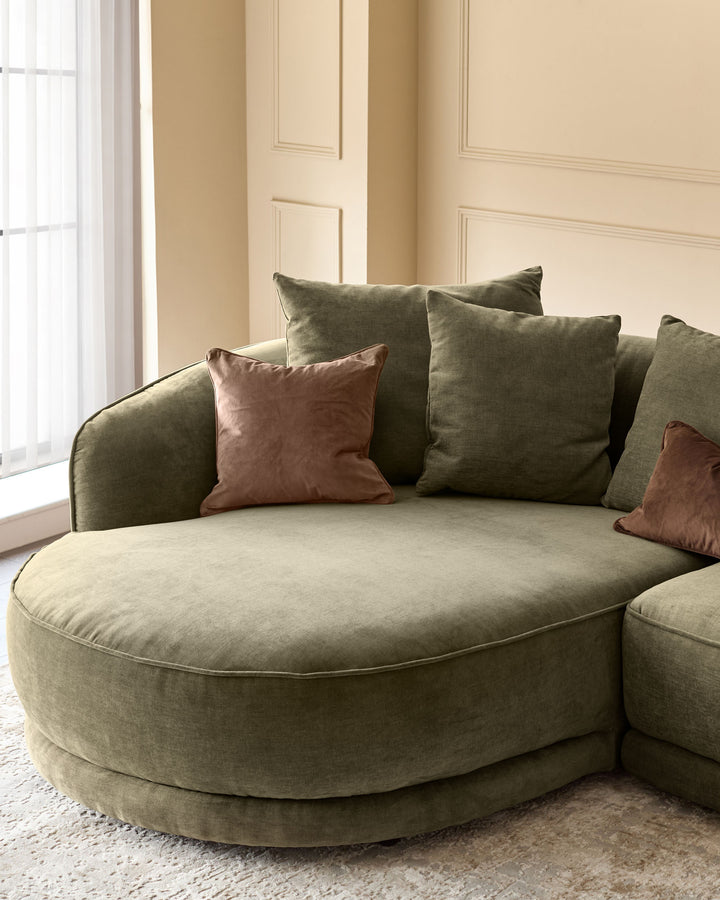 Caspian left-hand corner chaise sofa in olive green fabric with brown velvet cushions, positioned in a bright room with paneled walls.