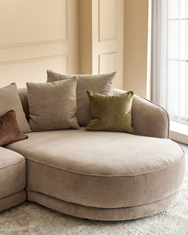 Caspian right-hand corner chaise sofa in mink fabric with decorative pillows in a neutral living room setting.