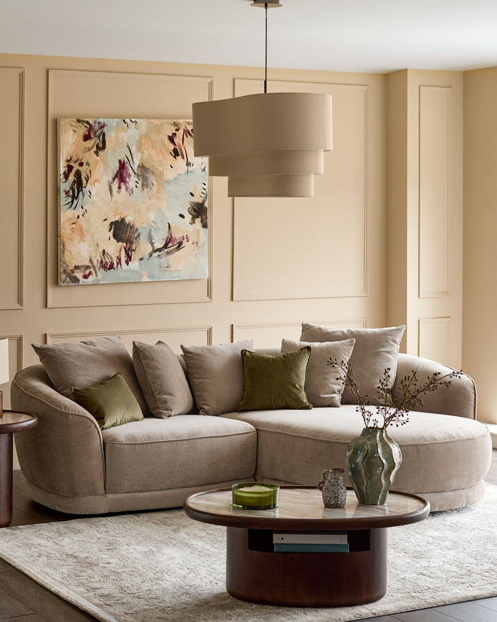 Caspian right-hand corner chaise sofa in mink fabric, curved design with rounded arms and multiple cushions in a neutral living room setting.