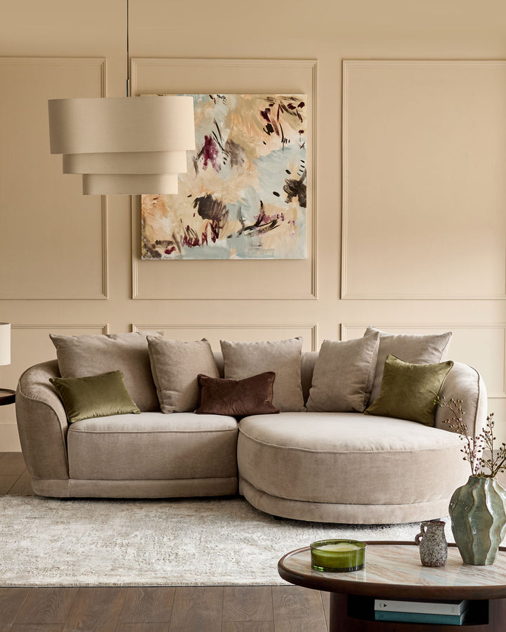 Mink fabric right-hand corner chaise sofa with curved armrests and rounded design in a neutral living room setting.