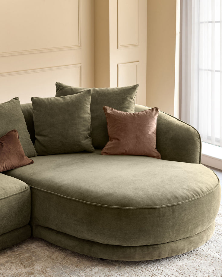 Caspian right-hand corner chaise sofa in olive green fabric with brown accent pillows, positioned in a bright room with neutral walls.