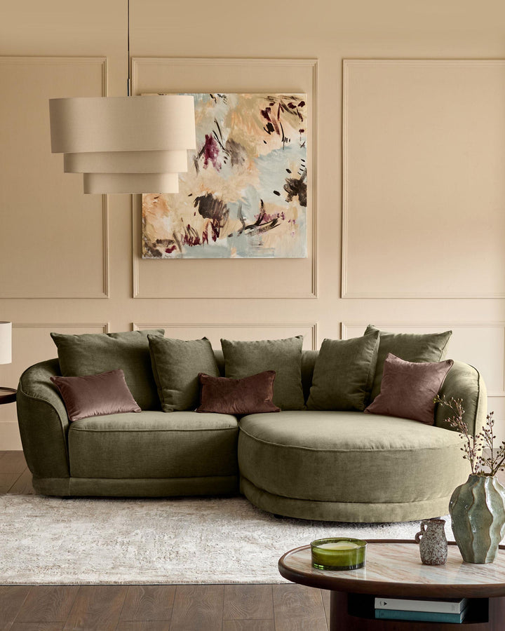 Caspian right-hand corner chaise sofa in olive green fabric, styled with burgundy and green cushions in a modern living room.