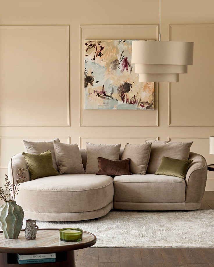 Caspian single module fabric sofa in mink, curved rounded design with rolled arms, styled with coordinating pillows in neutral room setting.