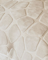 Close-up of Cassidy cushion in ivory, showing quilted texture and soft fabric detail.