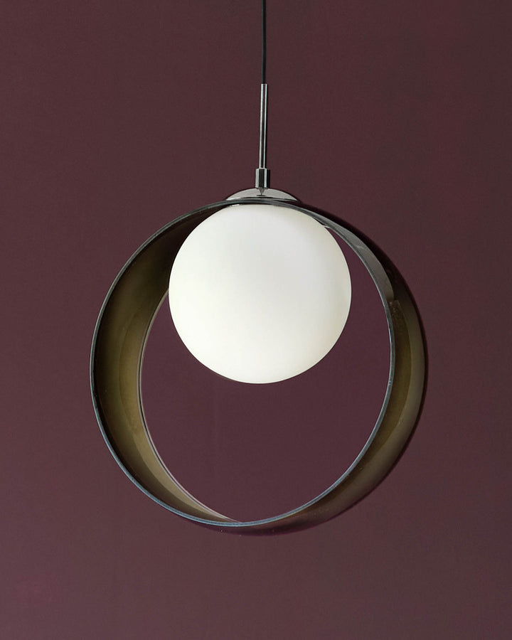 Chloe single pendant light with green-tinted glass ring and frosted white globe, hanging against burgundy background.