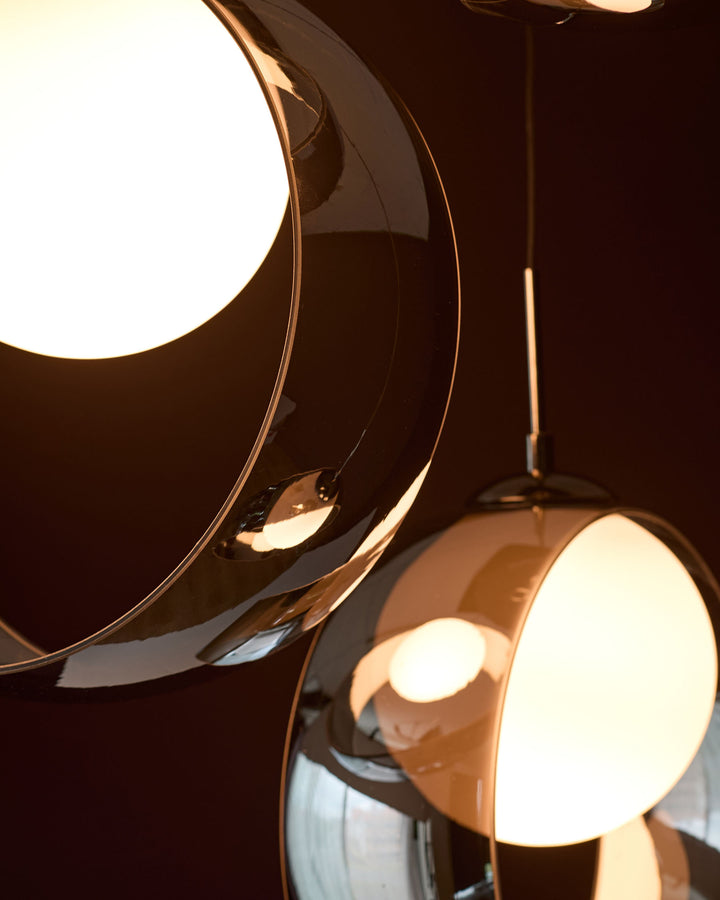 Chloe 4 pendant light with chrome finish and illuminated glass spheres, shown against dark background.