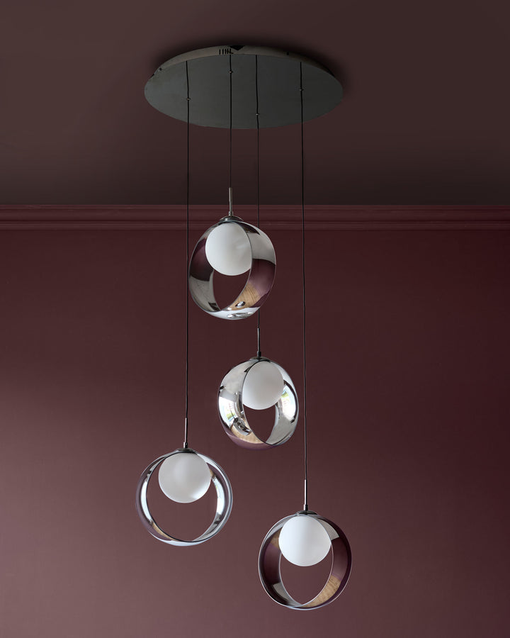 Chloe 4-pendant light with spherical glass shades in chrome finish, suspended from central canopy against burgundy wall.
