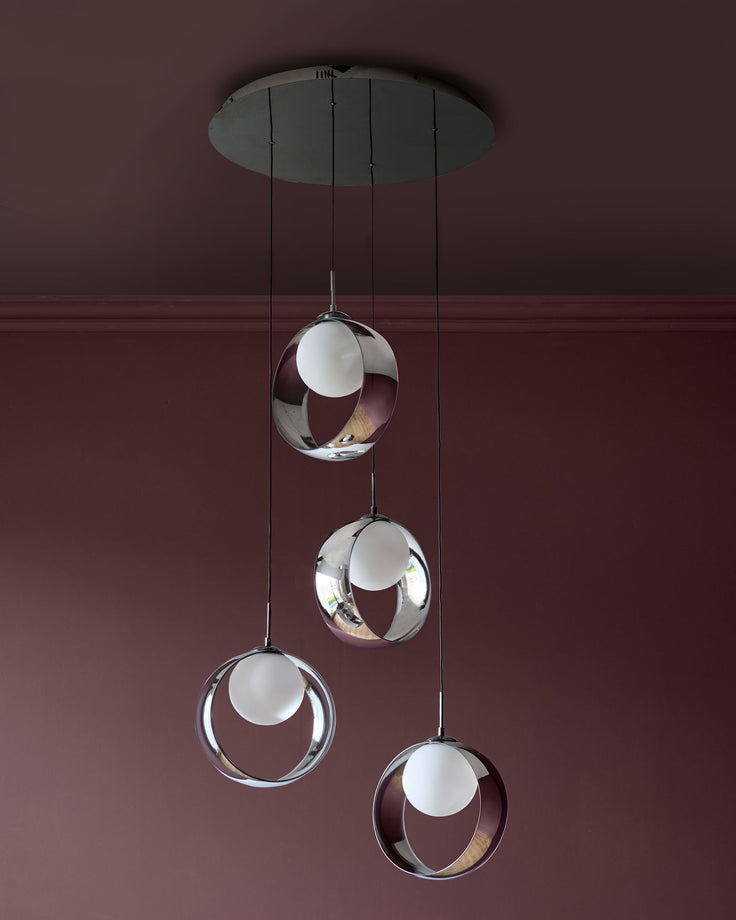 Chloe 4-pendant light with spherical glass shades in chrome finish, suspended from central canopy against burgundy wall.