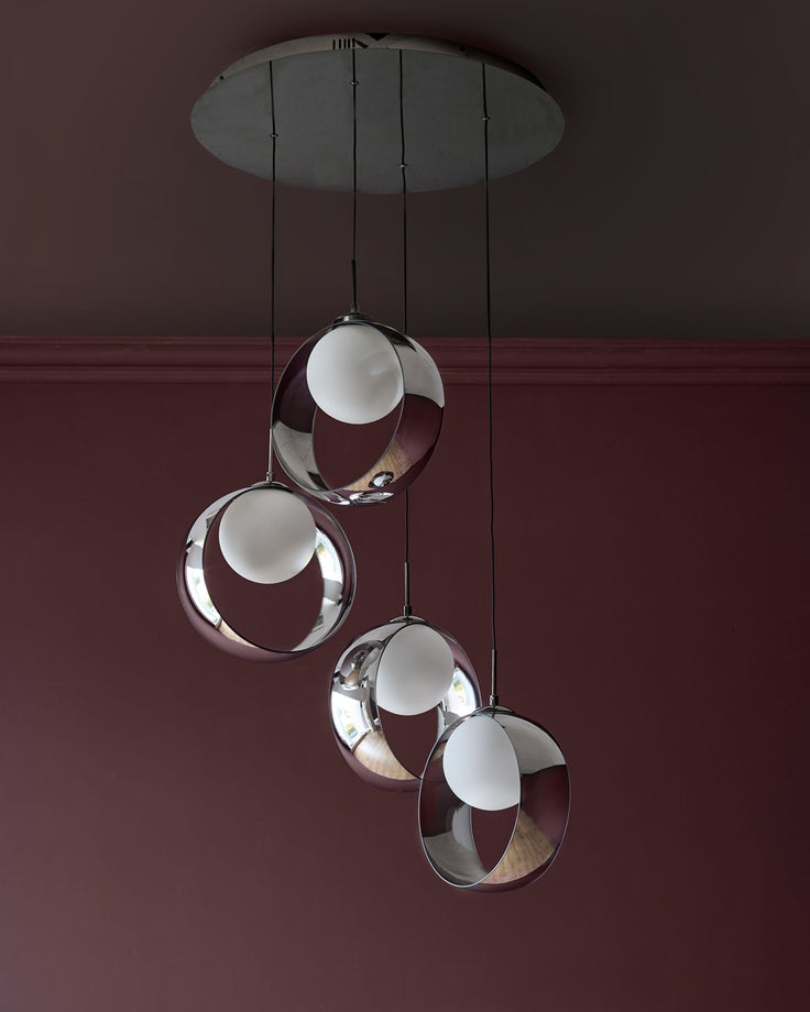 Chloe 4-pendant light with spherical glass shades in silver chrome finish, suspended from ceiling canopy against burgundy wall.