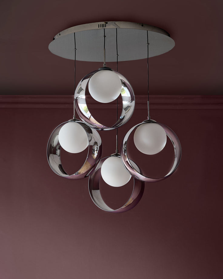 Chloe 4-pendant light with chrome base and four spherical smoked glass shades with frosted white centers, suspended from ceiling.
