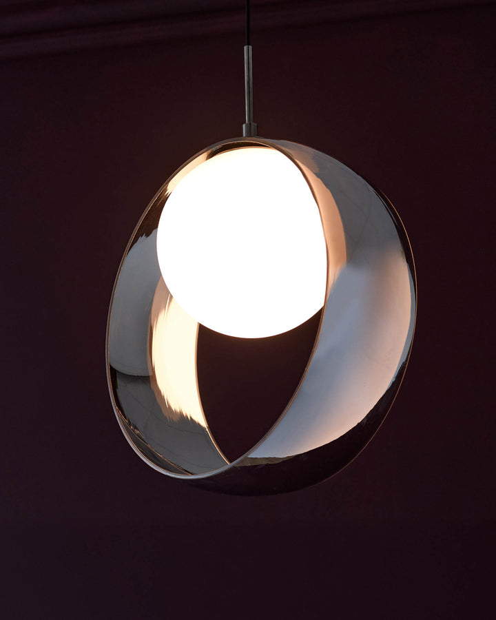 Chloe single pendant light with spherical chrome glass shade, illuminated against dark background, suspended by metal rod.