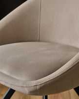 Cleo Velvet Swivel Chair in Champagne - close-up of curved seat and backrest showing soft velvet upholstery and stitched details.