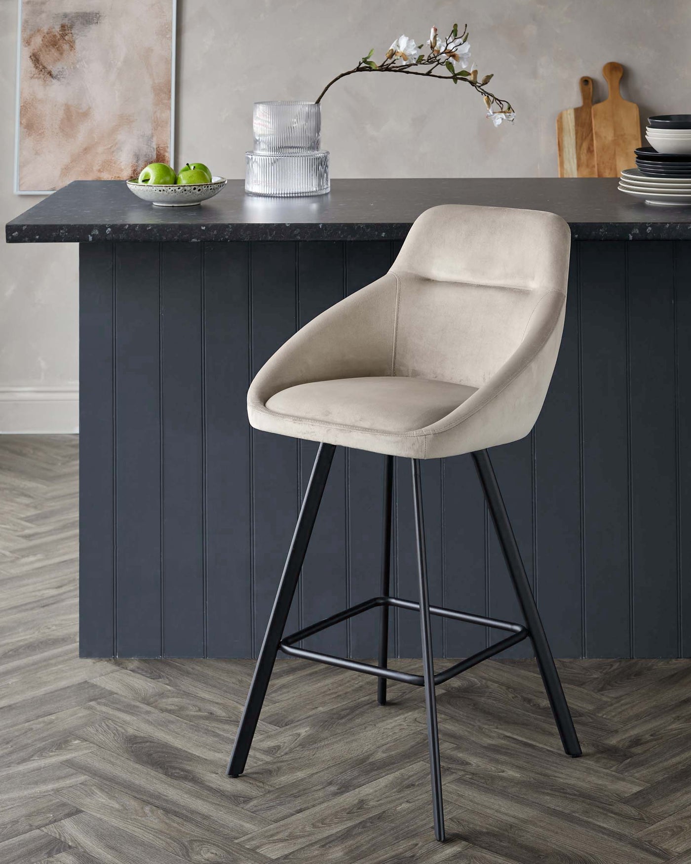 Modern bar stool with beige upholstered seat and backrest, featuring sleek black metal legs with footrest.