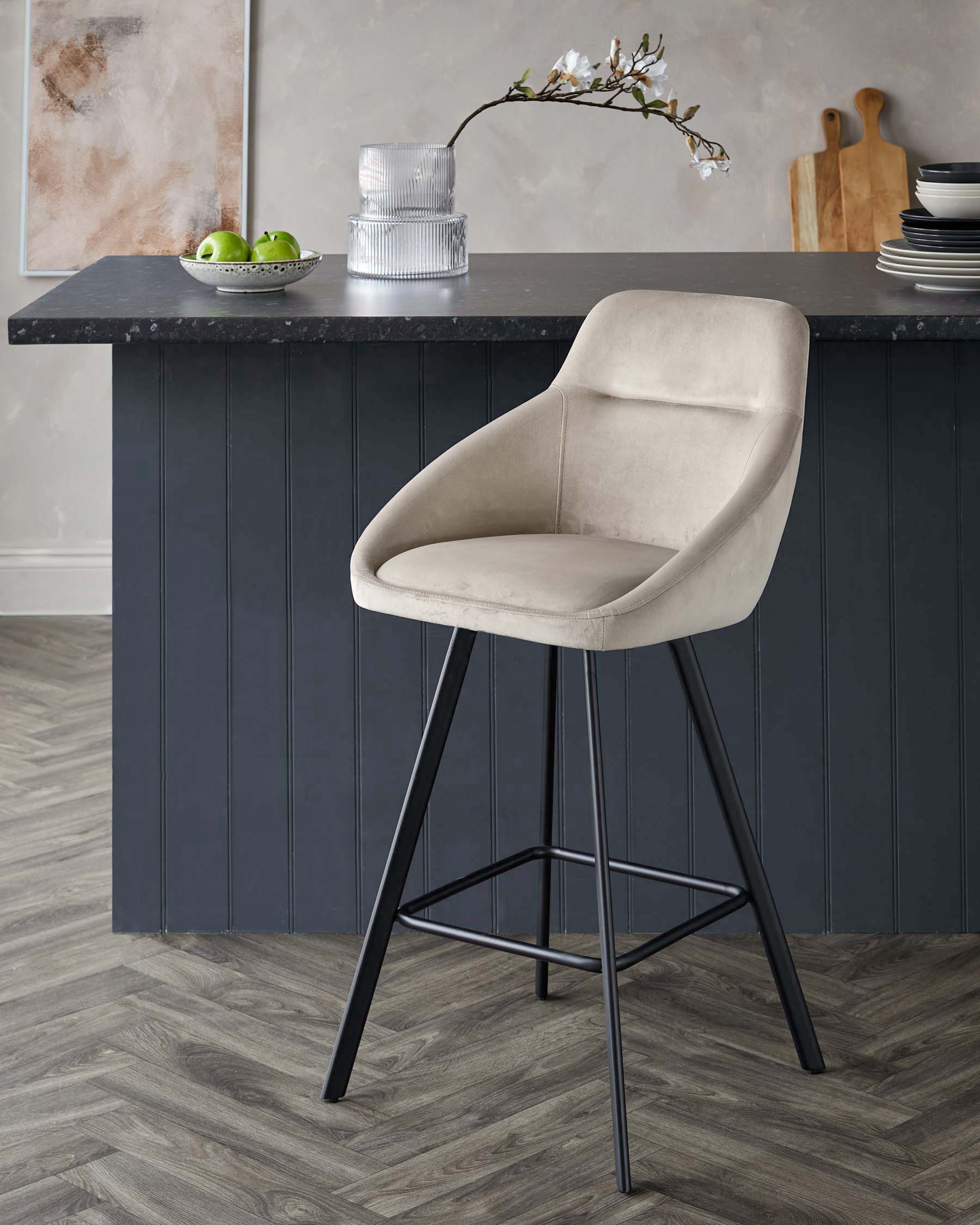 Stylish kitchen bar stool with a beige fabric seat and black metal legs. Modern design for a contemporary kitchen.