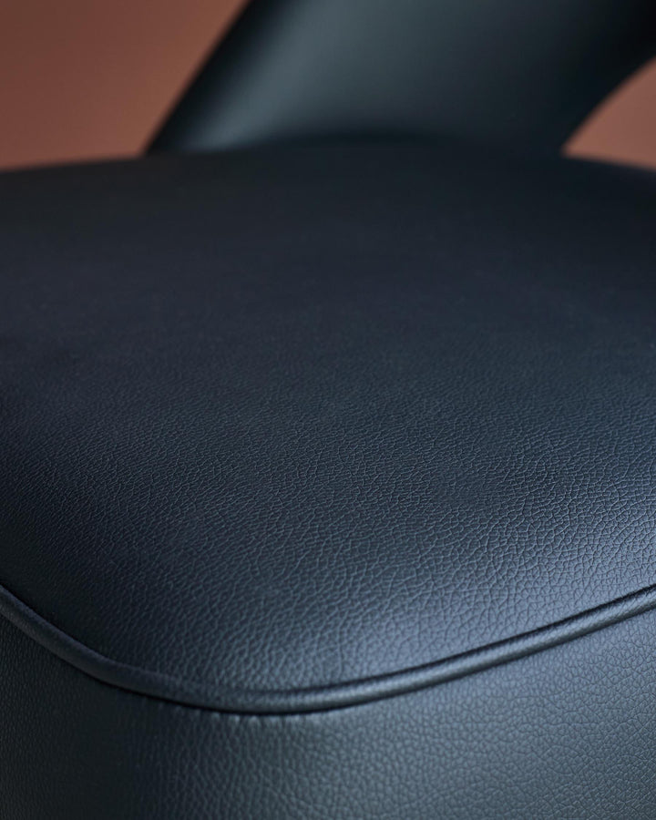Close-up of a textured, curved seat with piped edge. Comfortable and stylish seating solution.