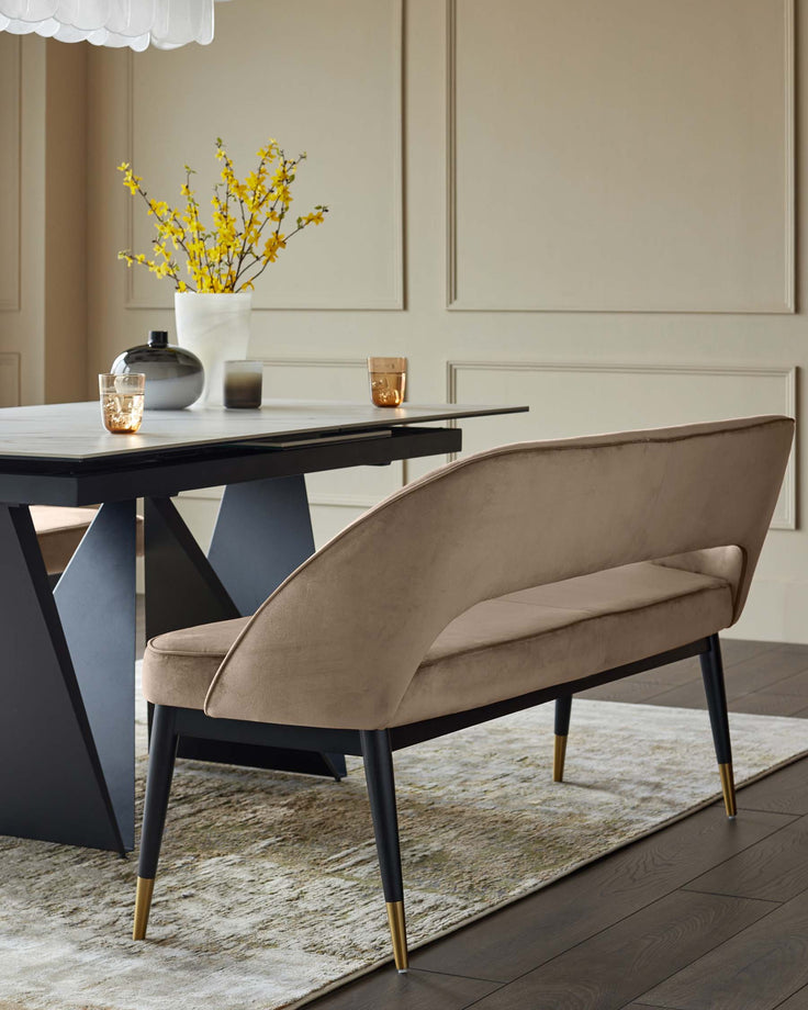 Stylish dining set with a modern table, curved bench featuring sleek black legs and a soft, inviting upholstery.