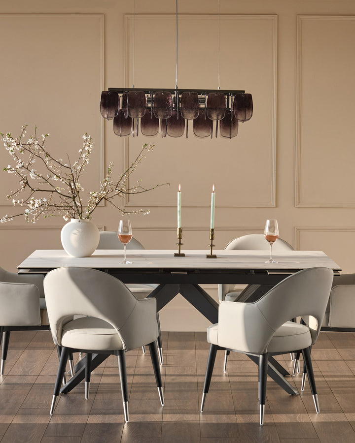 Clover dining armchair in light grey faux leather with black metal legs, shown in elegant dining room setting.