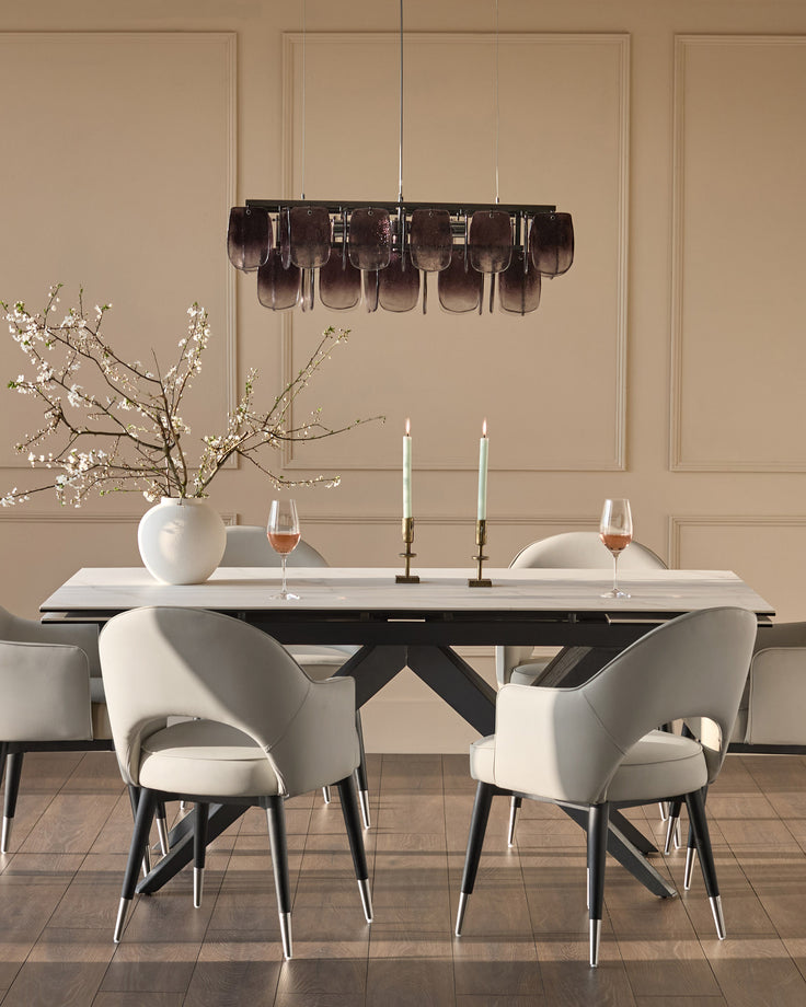 Clover dining armchair in light grey faux leather with black metal legs, shown in elegant dining room setting.