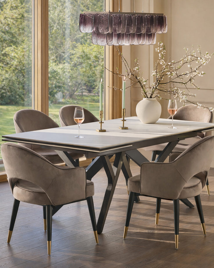 Clover mocha velvet dining armchair with black wooden legs and gold metal accents, shown in dining setting.