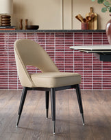 A modern dining chair with a curved back and tapered legs, sat on a wooden floor. Contemporary and stylish furniture.