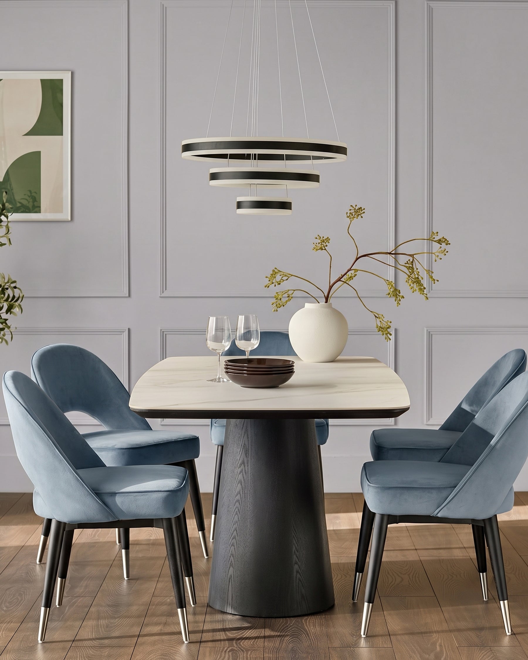 Clover velvet dining chair in blue with black legs and stainless steel caps, shown in dining room setting.