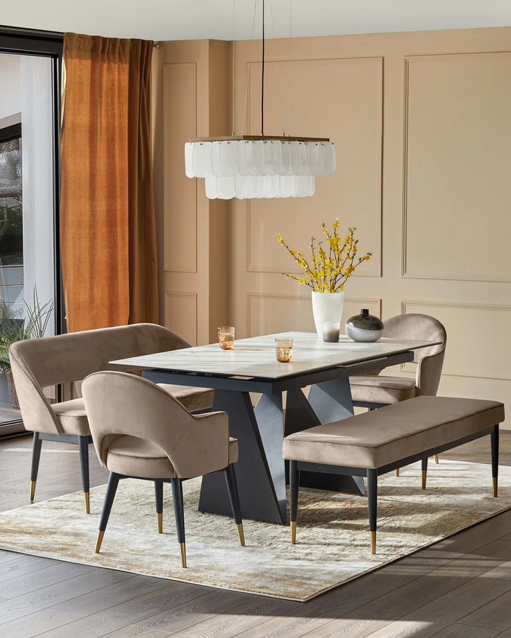 A modern dining set featuring a white marble table, beige velvet chairs, and a unique chandelier.