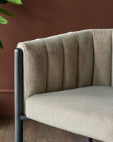 Close up of a modern chair with a grey fabric seat and backrest, and a black metal frame.