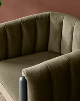 A stylish, upholstered armchair in an olive green hue, featuring a channel-back design.