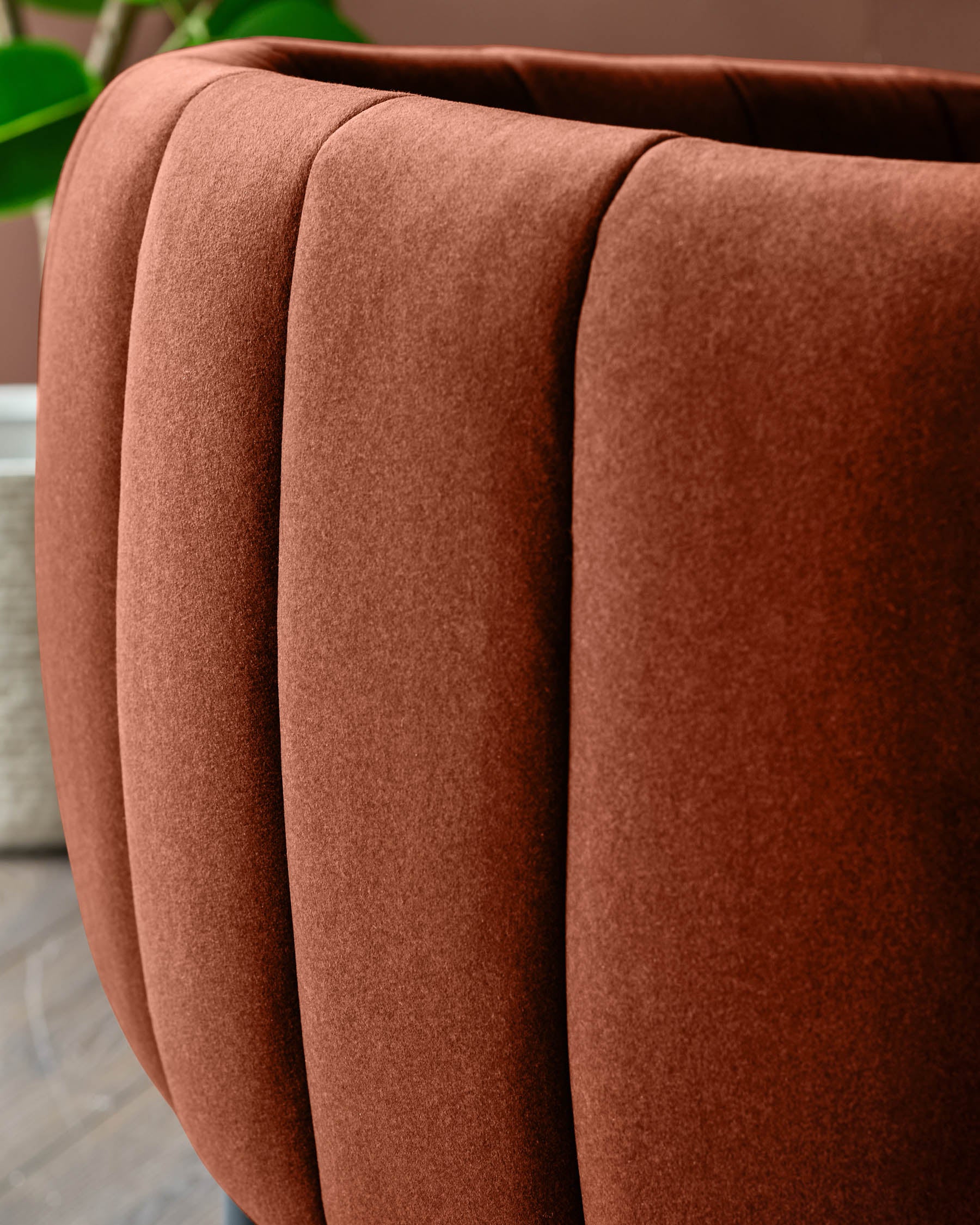Close up of a burnt orange fluted velvet chair. Modern and stylish furniture detail.