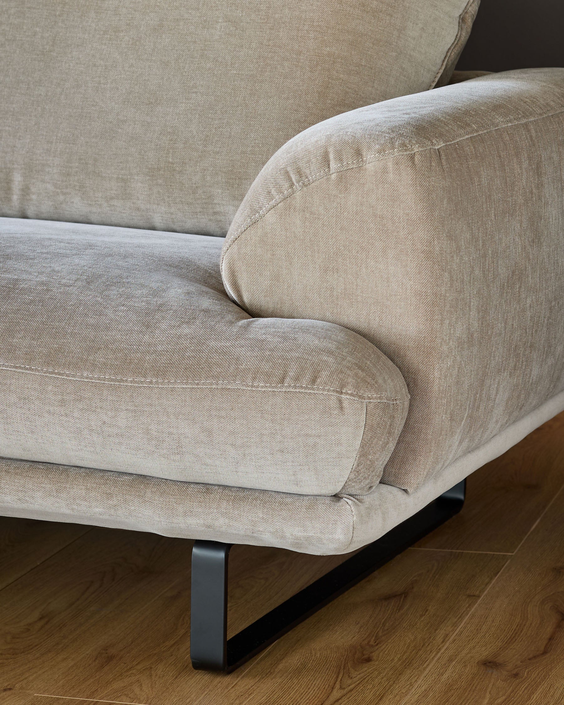 Colette right-hand corner chaise sofa in mink fabric, shown from side angle with metal feet on wooden floor.