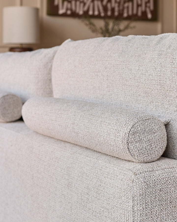 Colette left-hand corner chaise sofa in natural fabric, showing close-up of rolled arm detail and textured upholstery.