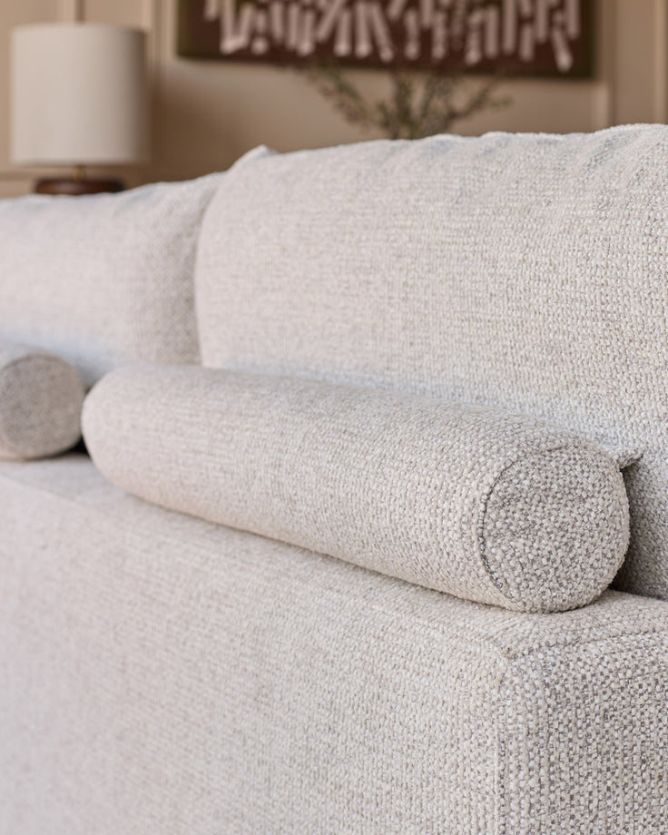 Colette left-hand corner chaise sofa in natural fabric, showing close-up of rolled arm detail and textured upholstery.