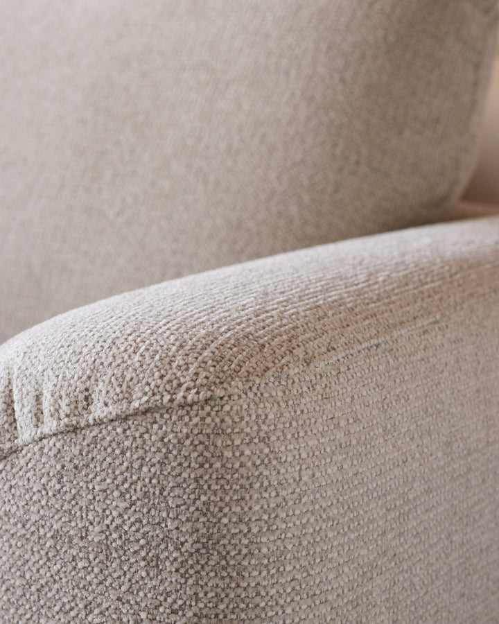 Close-up of natural beige fabric texture on Colette left-hand corner chaise sofa arm and back cushion.