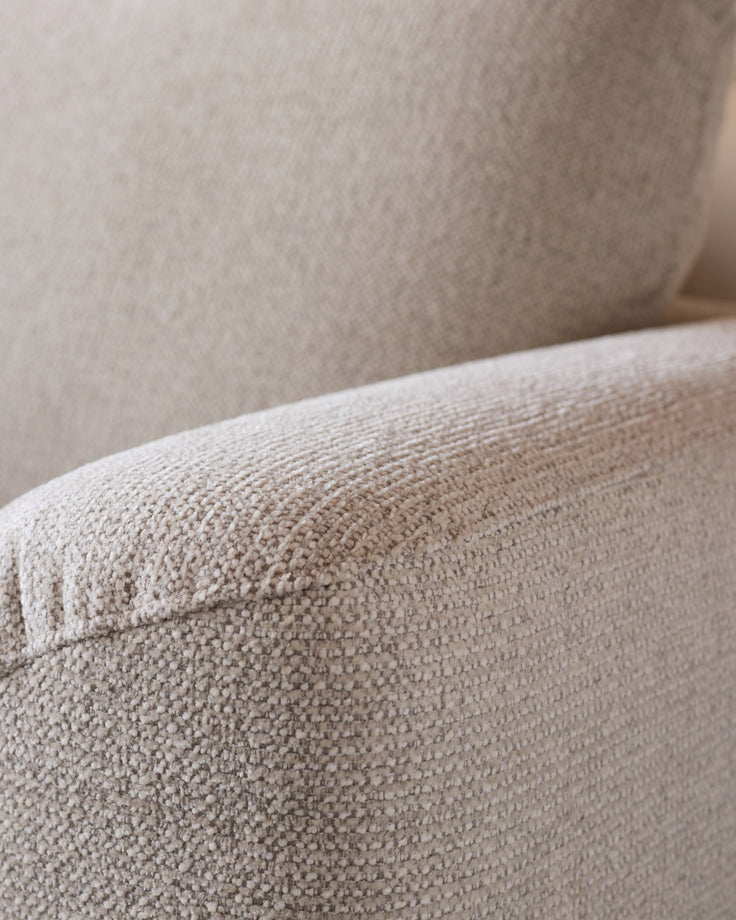 Close-up of natural beige fabric texture on Colette left-hand corner chaise sofa arm and back cushion.