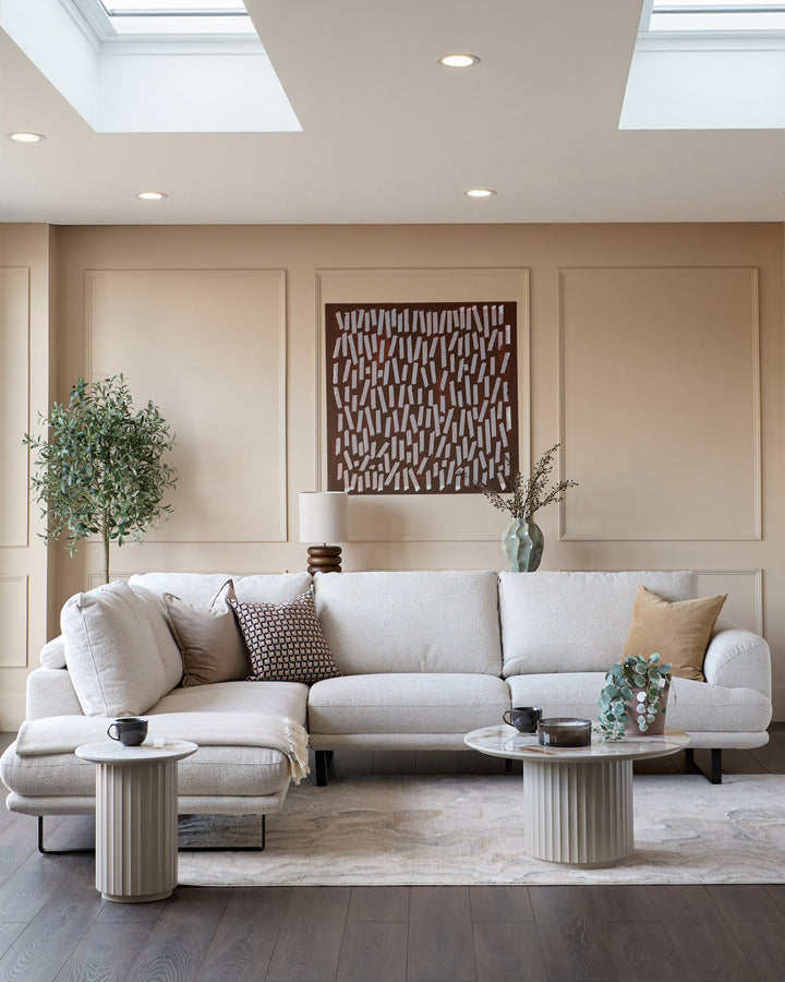 Colette left-hand corner chaise sofa in natural fabric, displayed in a modern living room setting with coordinating pillows.
