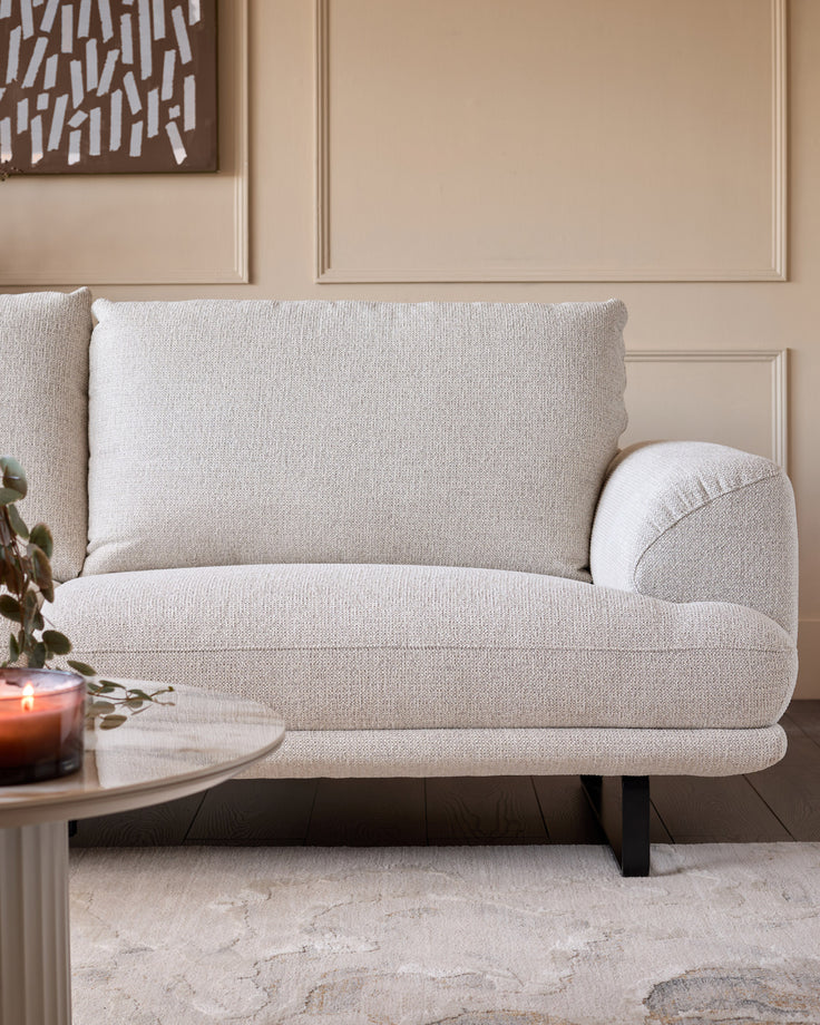 Colette right-hand corner chaise sofa in natural fabric, showcasing curved armrests and plush cushioning in a styled living room.