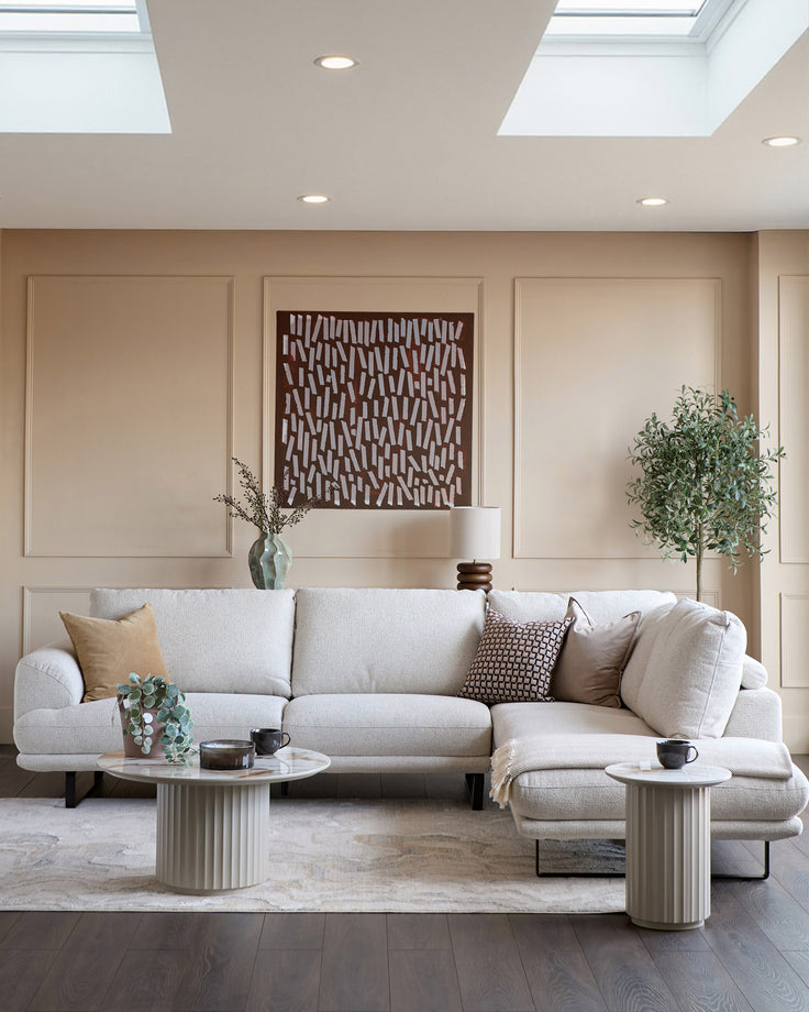 Colette right-hand corner chaise sofa in natural fabric, displayed in a modern living room setting with coordinating pillows.