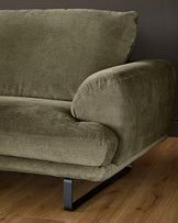 Colette left-hand corner chaise sofa in olive green fabric with dark metal legs, angled side view on wooden flooring.